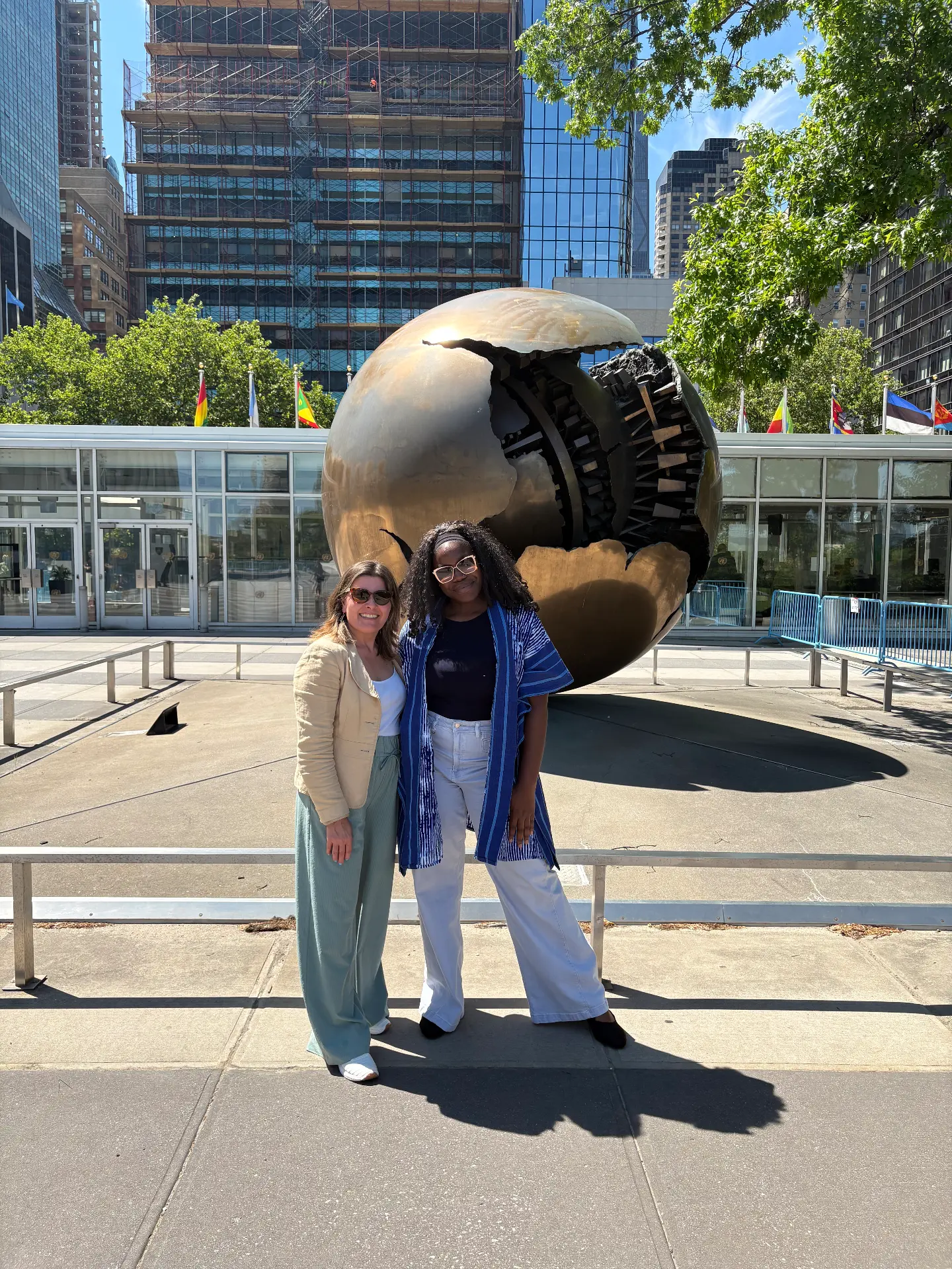 Ibi Kontein with a colleague at the United Nations Headquarters Sphere sculpture during COSP19